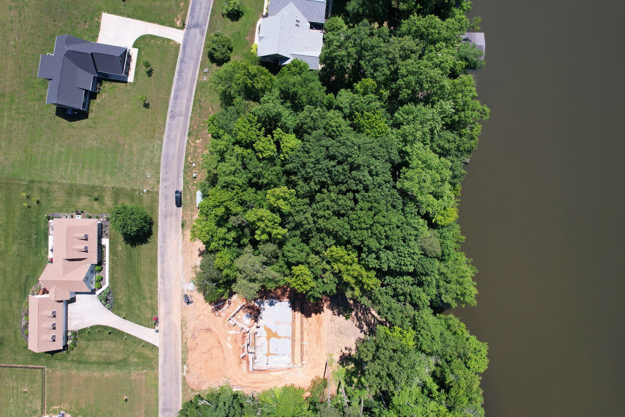 an aerial view of a house with garden space and street view