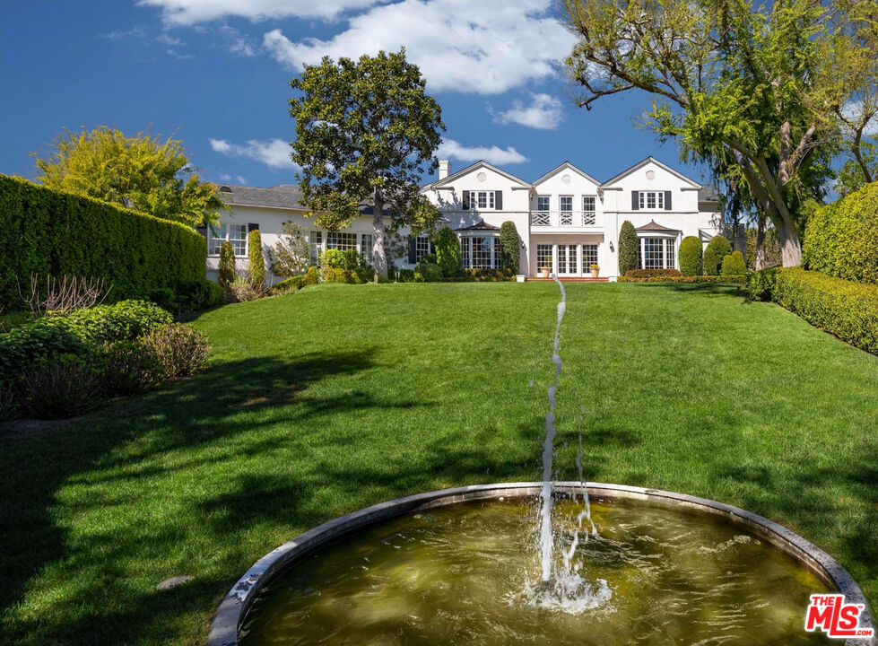 a swimming pool with outdoor seating and yard