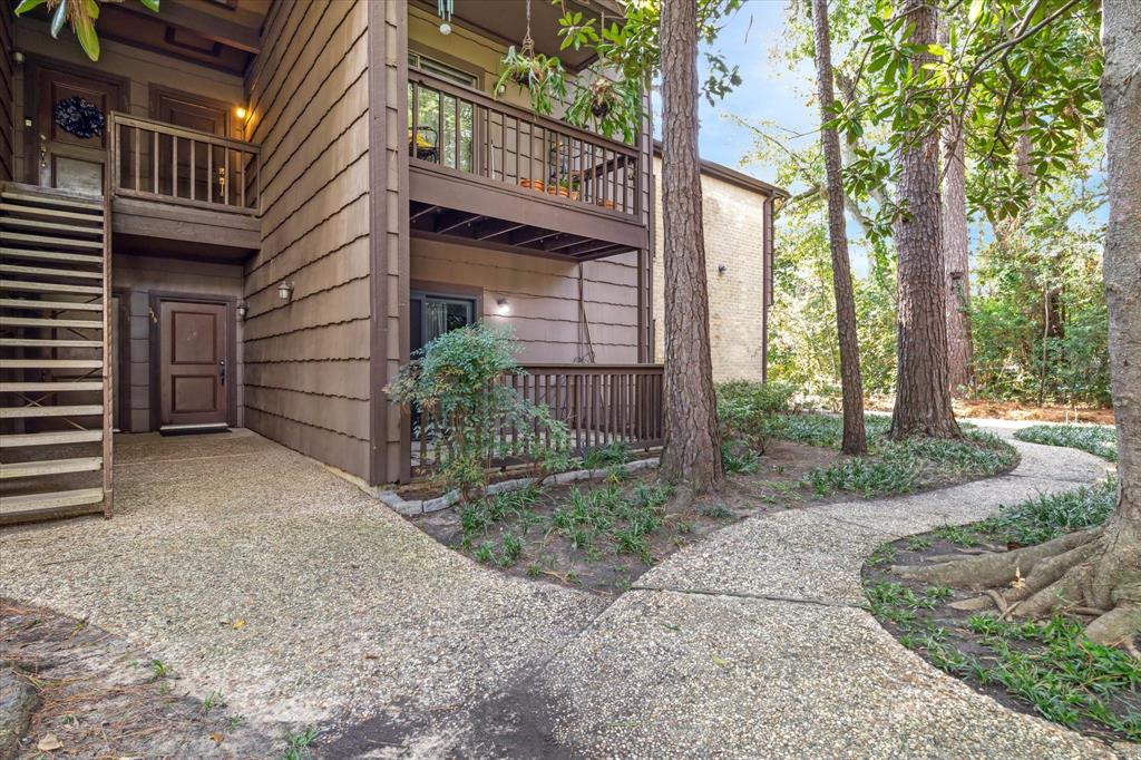 a view of a house with a yard and pathway