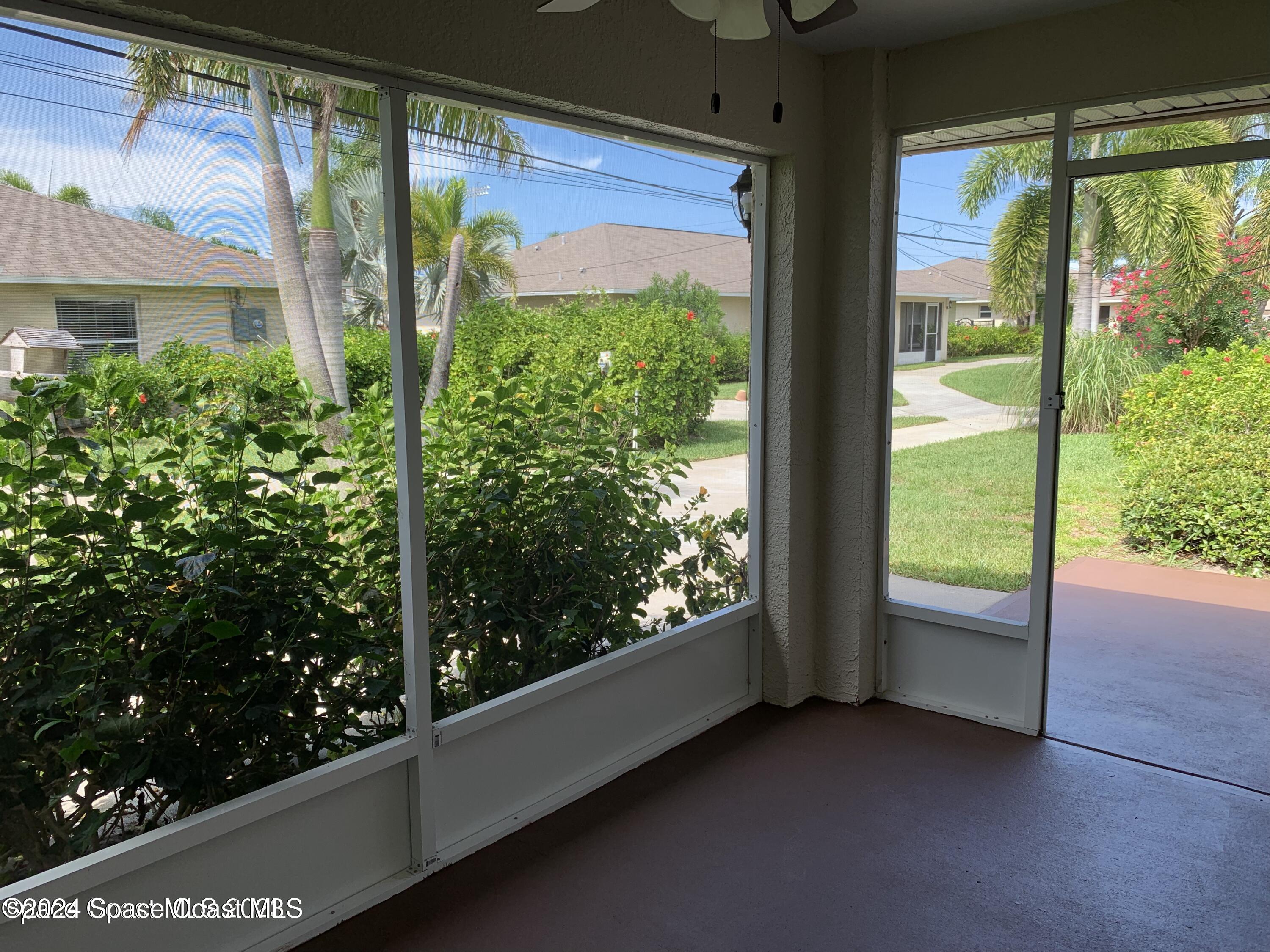 a view of a glass door with a yard from a balcony