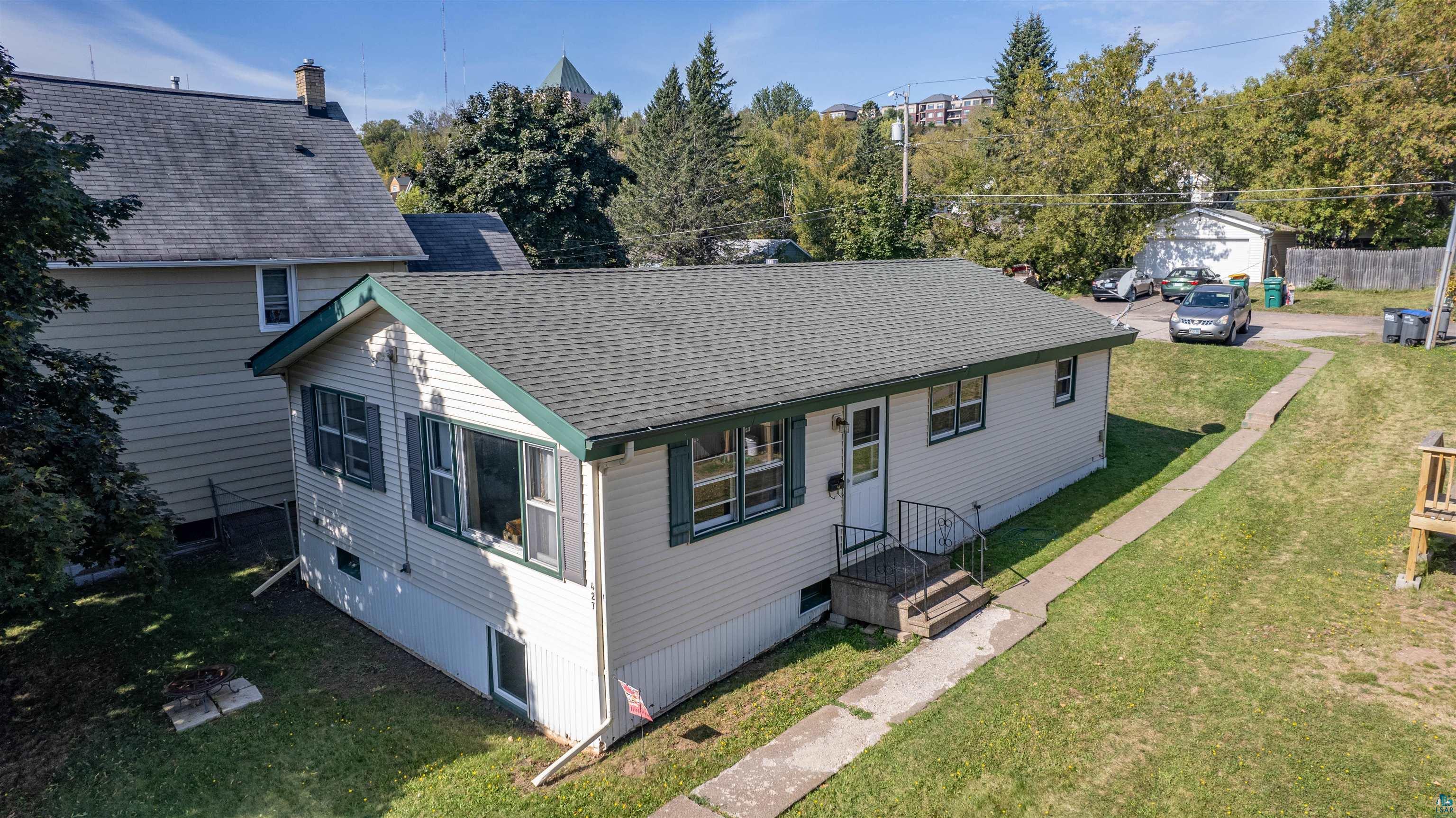 View of front of home featuring a garage and a front yard