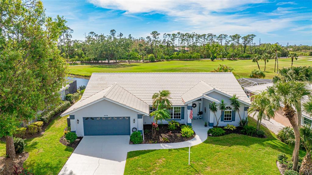 a view of a house with a yard and a patio