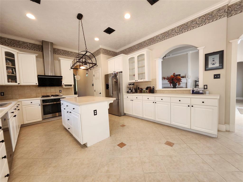 a kitchen with a sink stove and cabinets