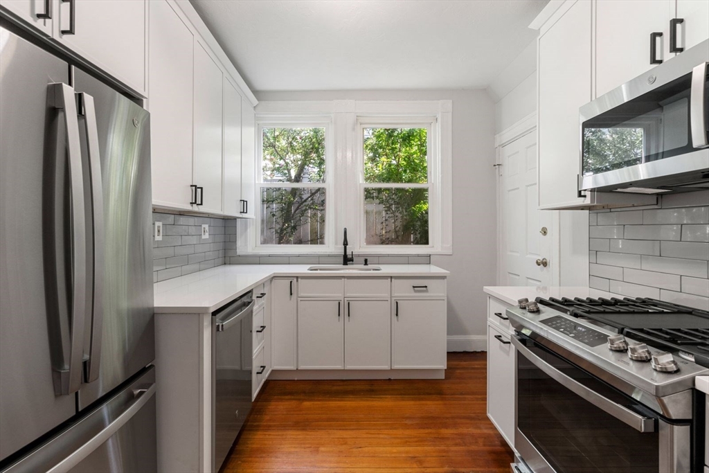 a kitchen with a sink stove and refrigerator