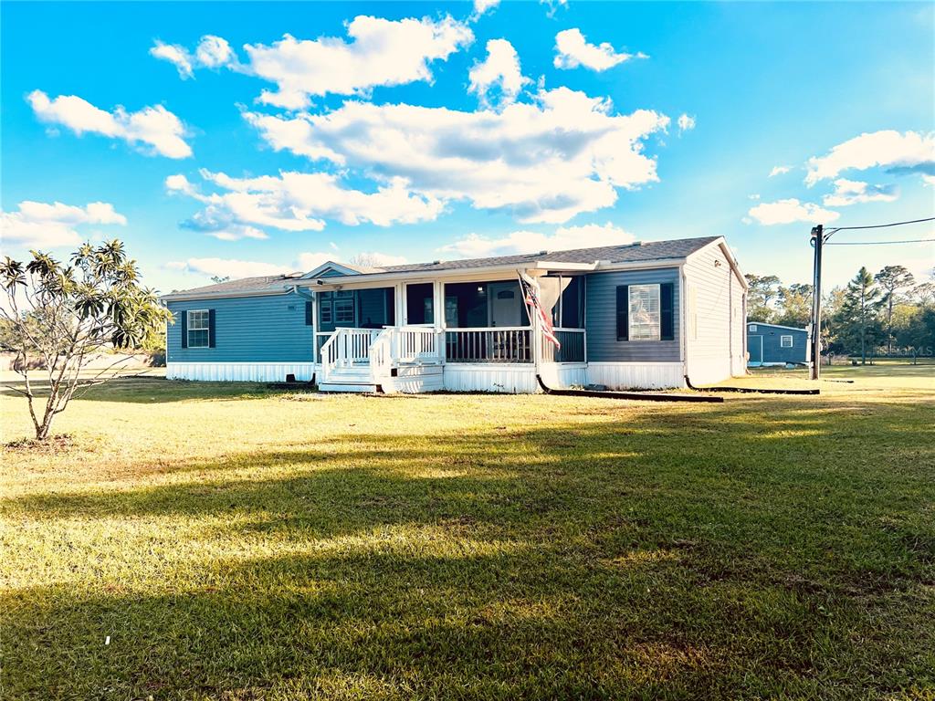 a front view of house with outdoor space and swimming pool