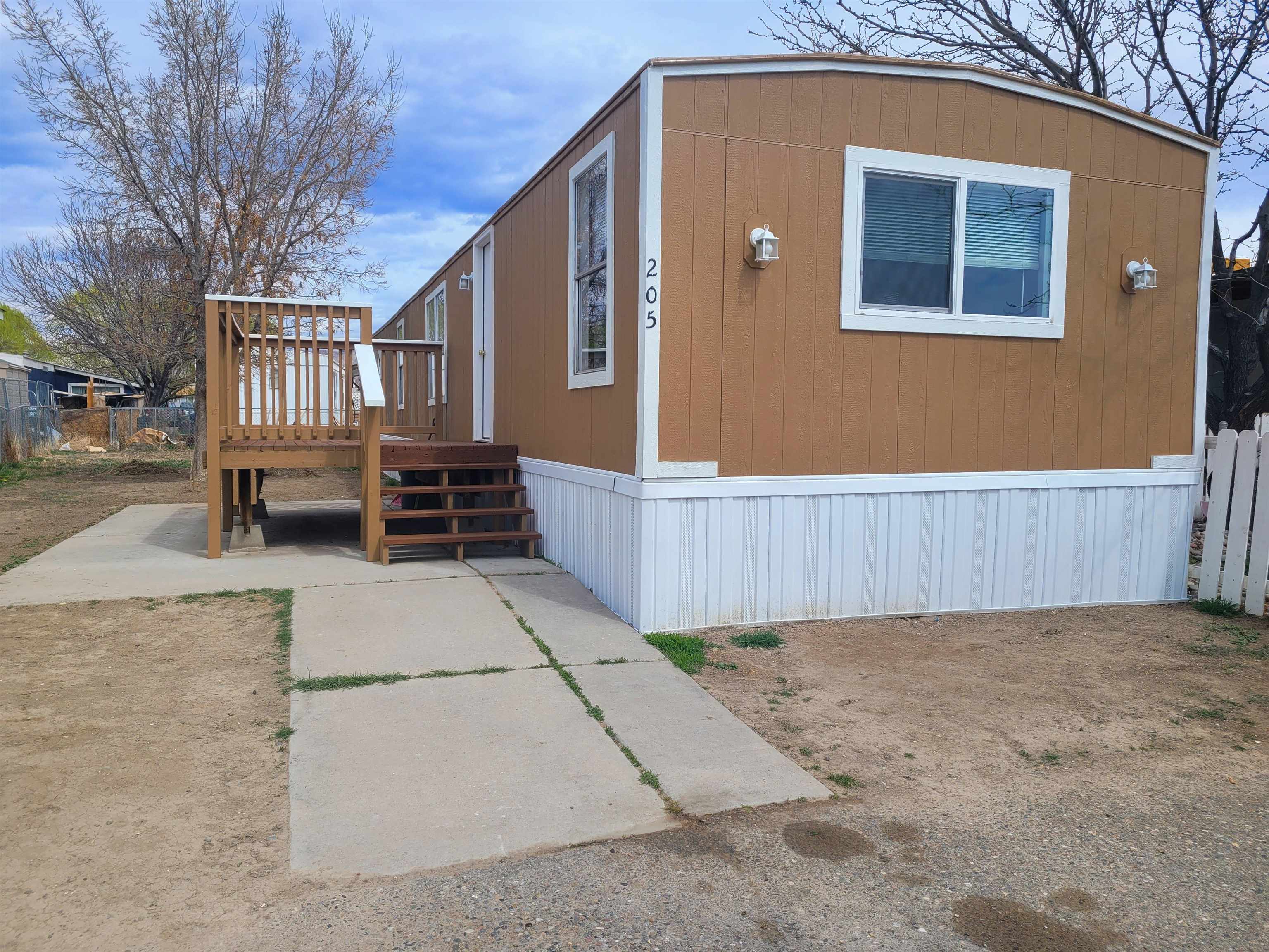 a front view of a house with a bench