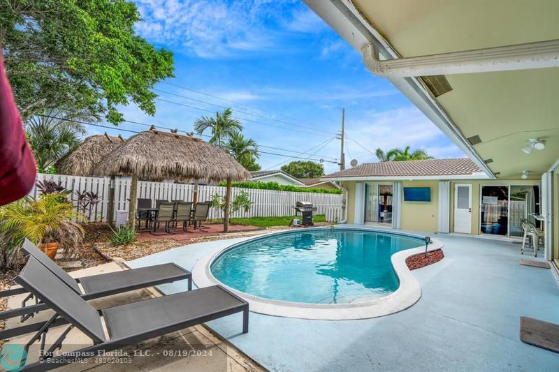 an outdoor space with swimming pool and furniture