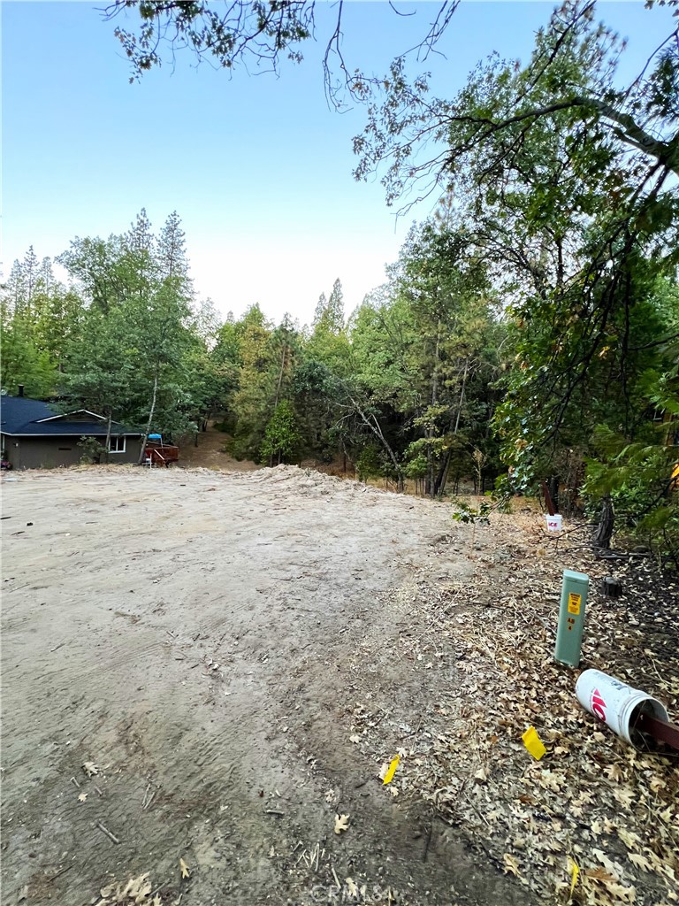 a view of yard with wooden fence