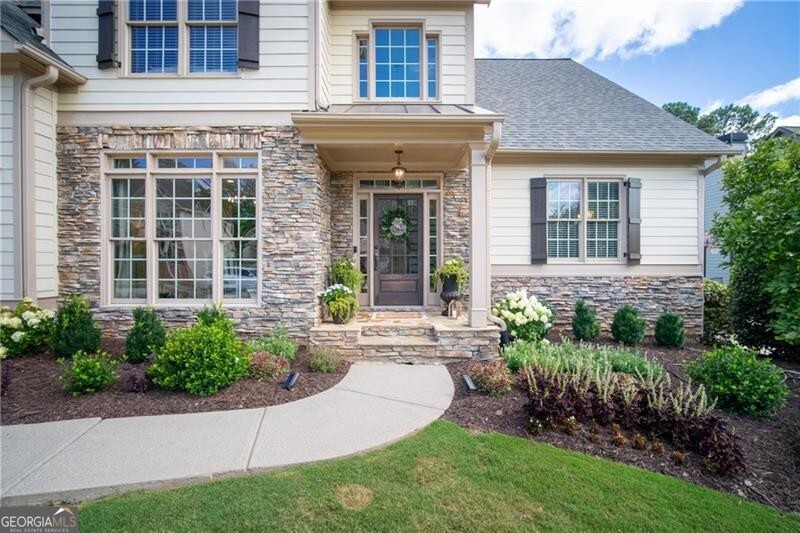 front view of a brick house with a yard