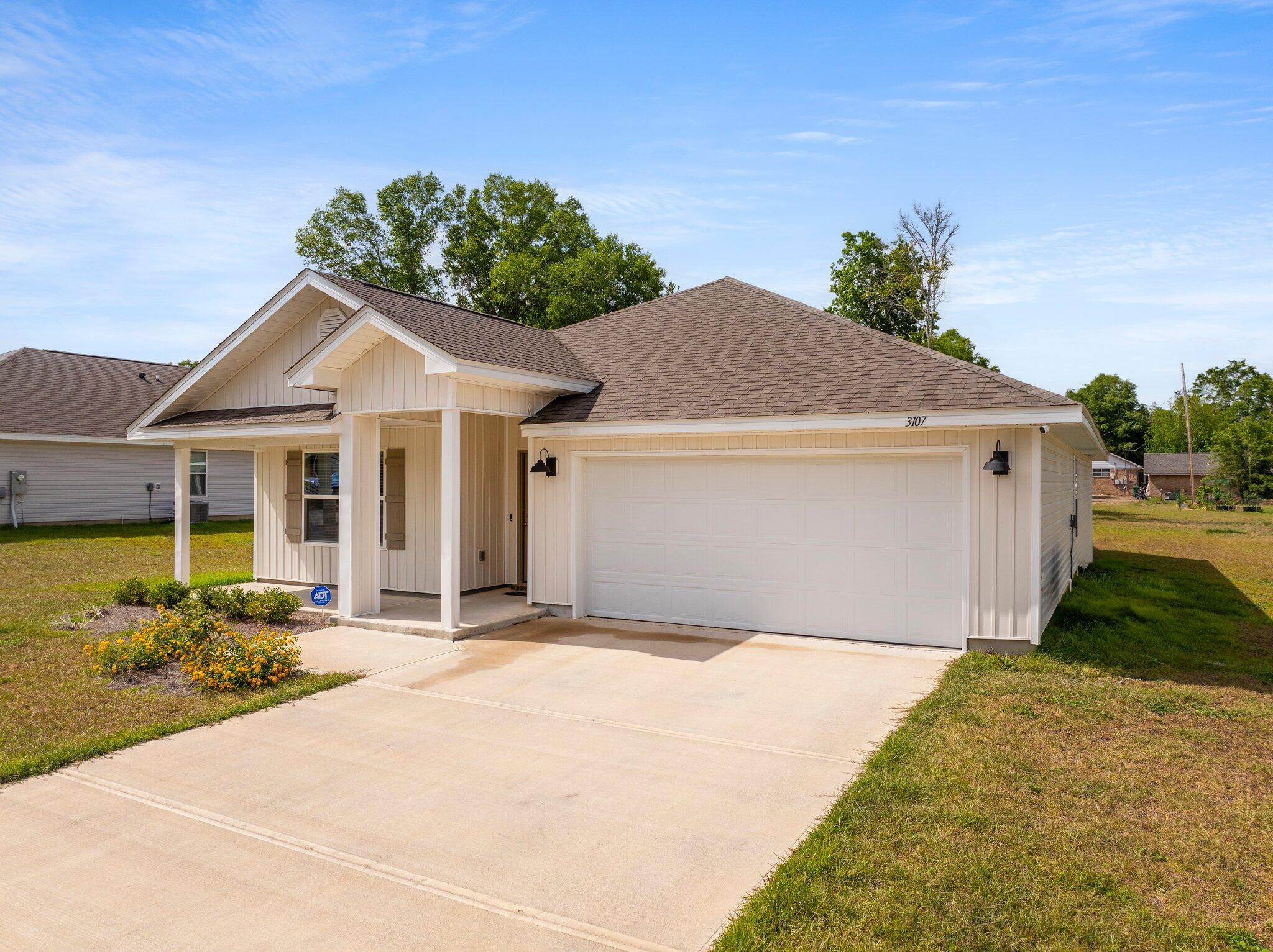 a front view of a house with garden