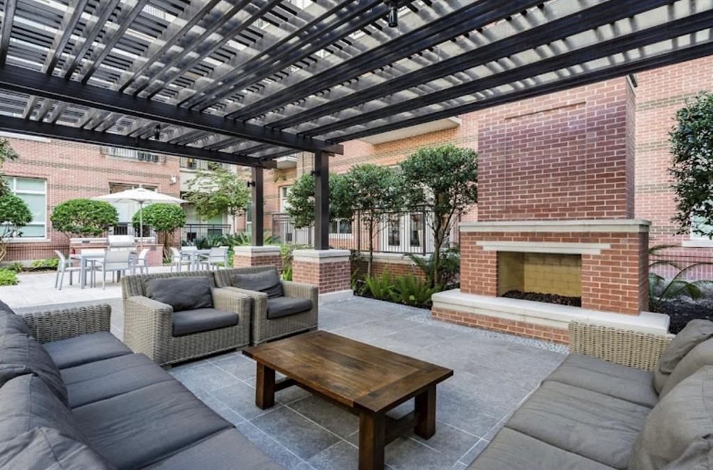 a outdoor living space with patio furniture and a fireplace