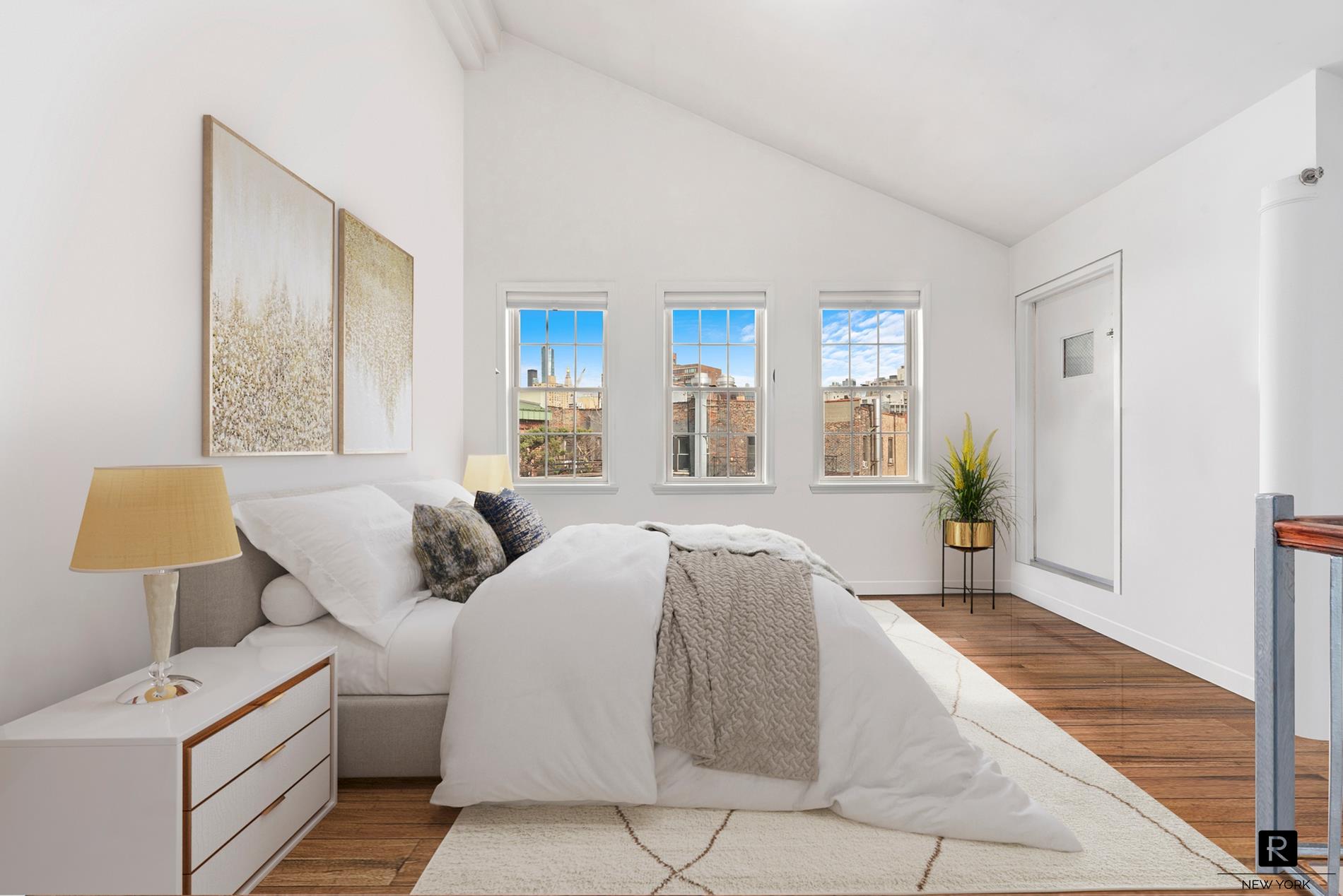 a spacious bedroom with a bed and a window