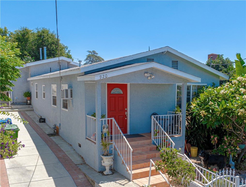 a front view of house along with deck and entertaining space