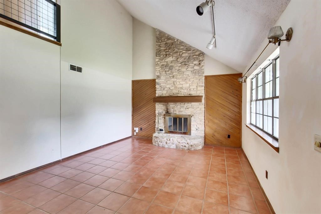 a view of a livingroom with a fireplace and window