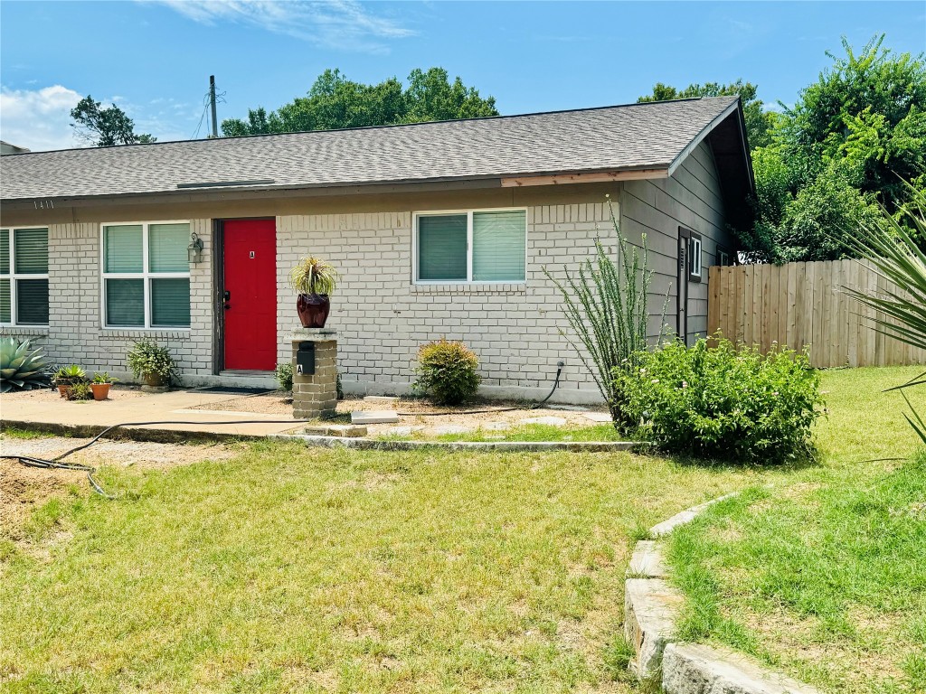 a view of house with swimming pool and yard