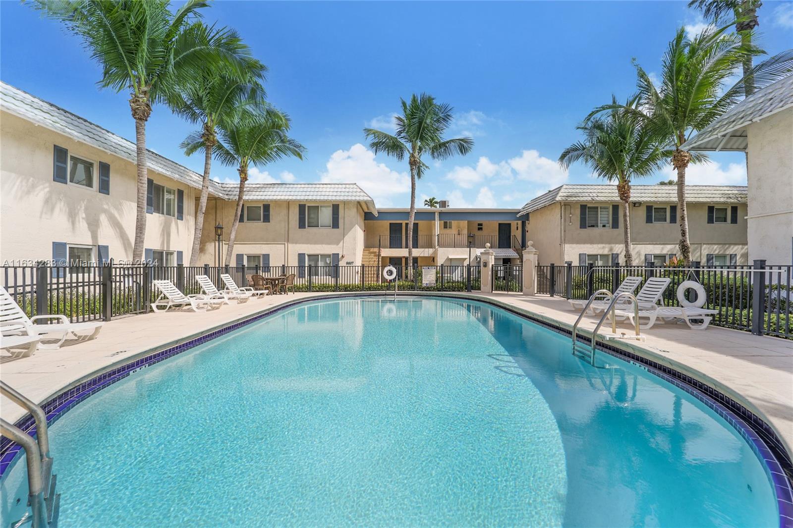 a swimming pool view with a outdoor seating