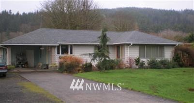 a front view of a house with a garden and yard