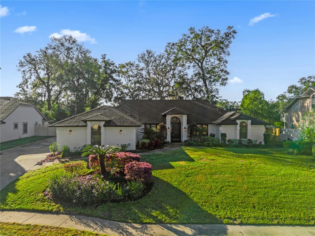 a front view of house with yard and green space