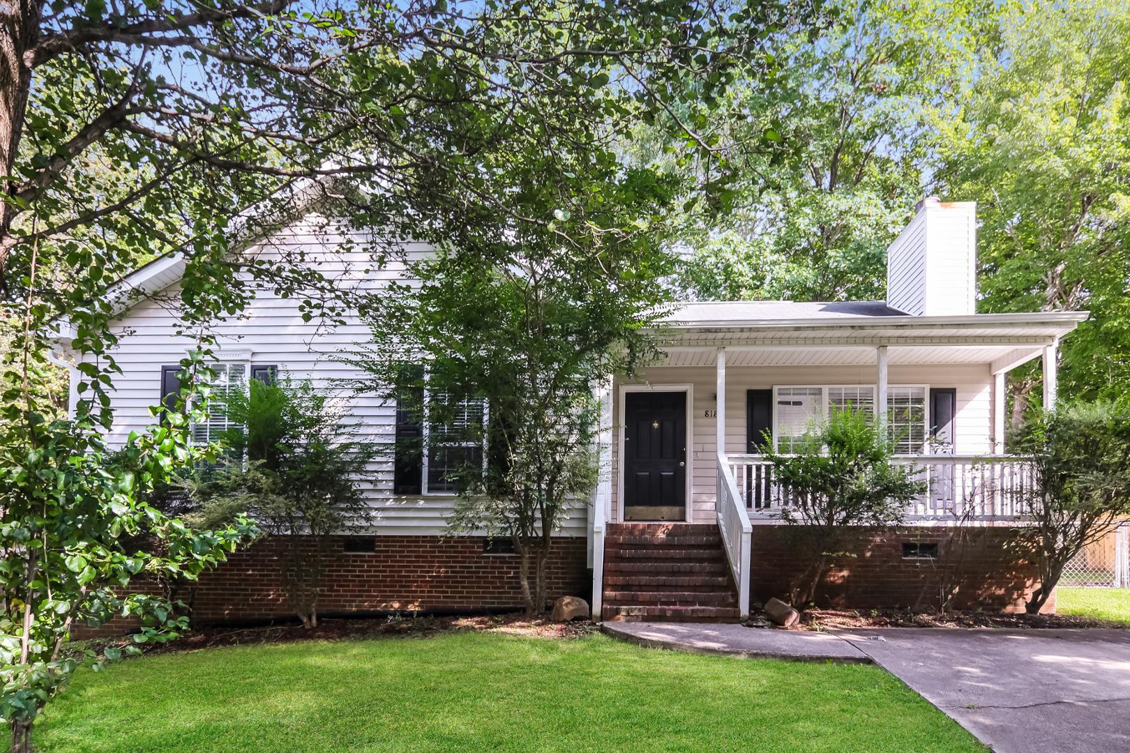 a front view of a house with a garden