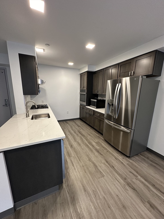 a kitchen with stainless steel appliances a refrigerator and a sink