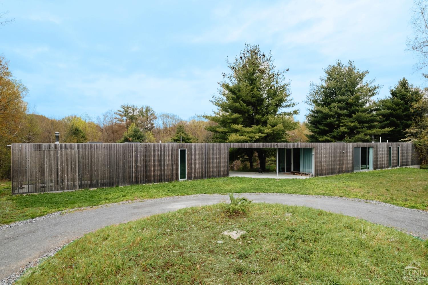 a front view of a house with a yard and trees