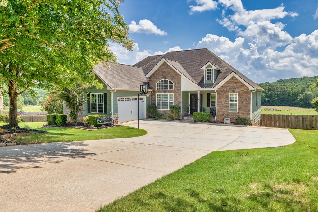 a front view of a house with a yard and garage