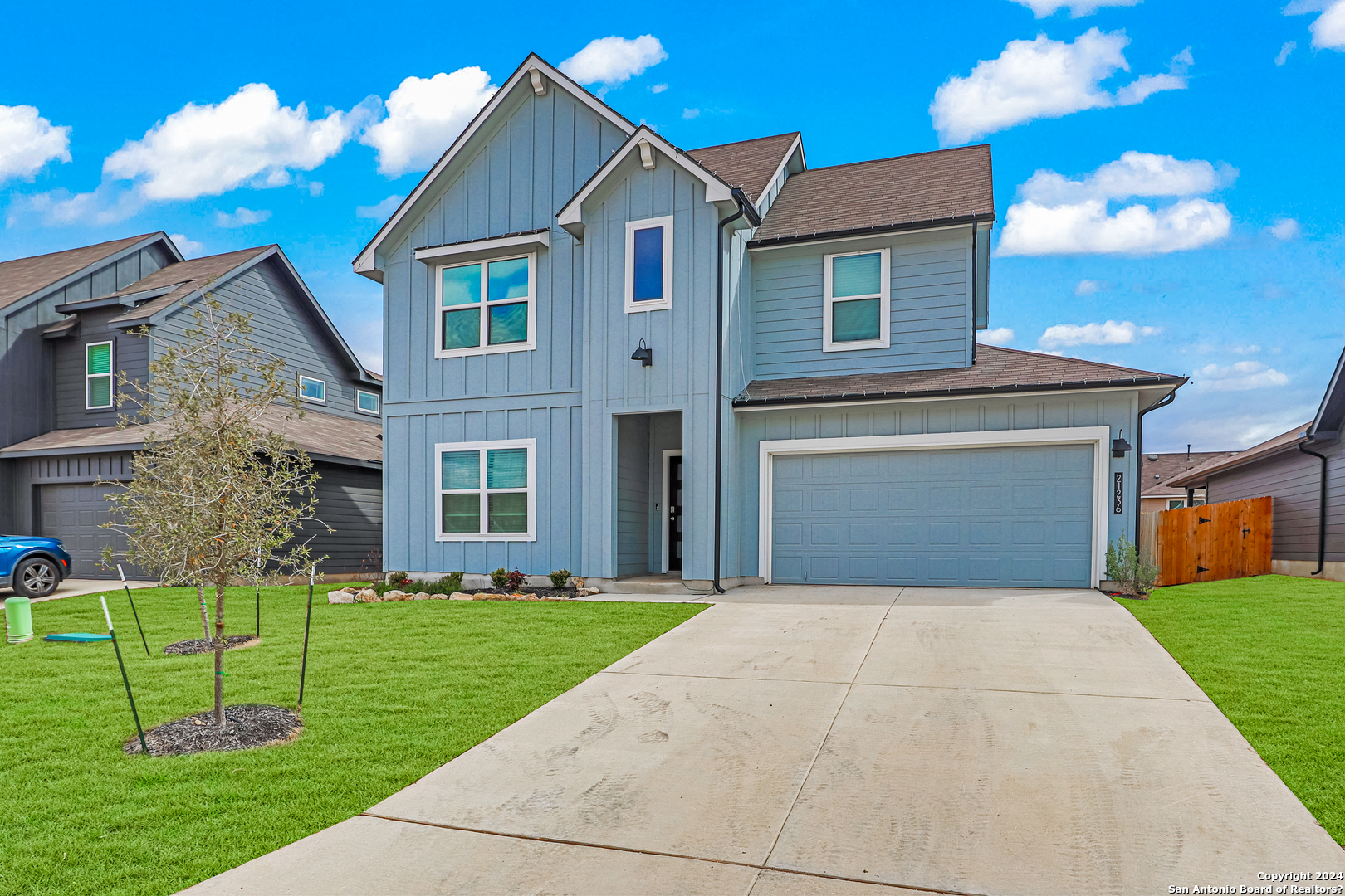 a front view of a house with a yard and garage