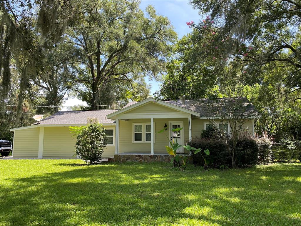 a front view of house with yard and green space