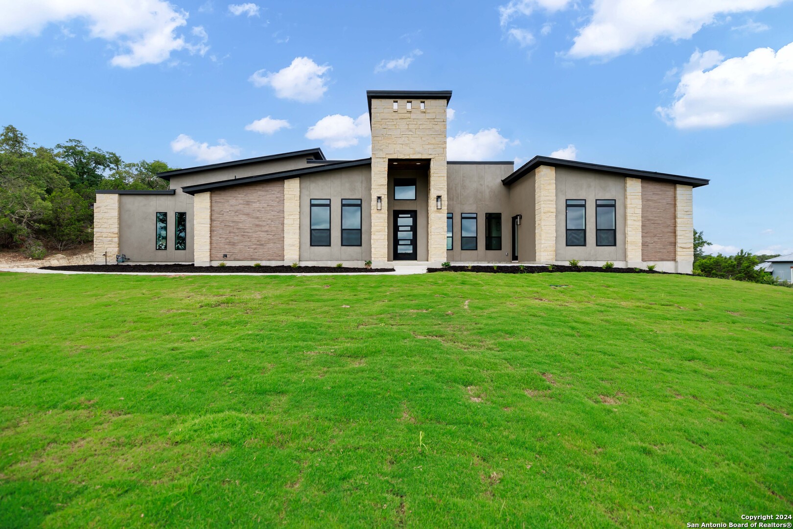 a front view of a house with a yard