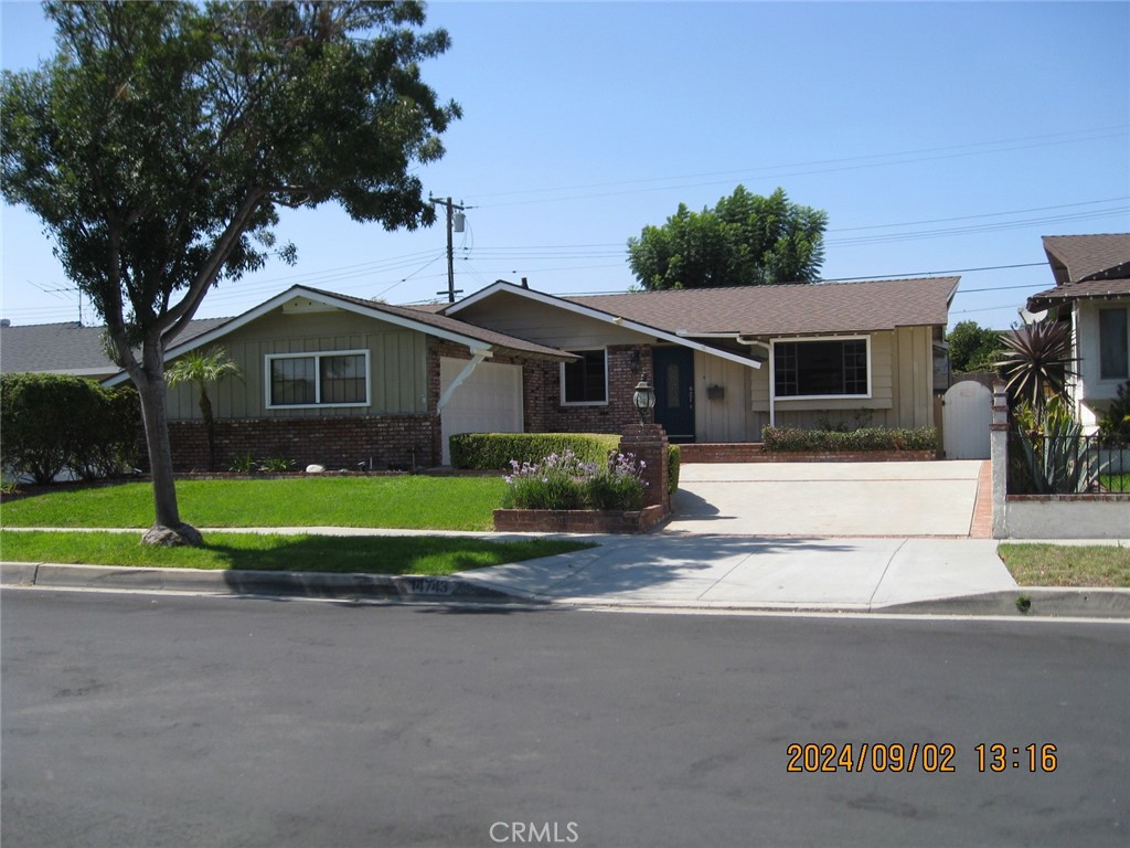 a front view of a house with a yard and porch