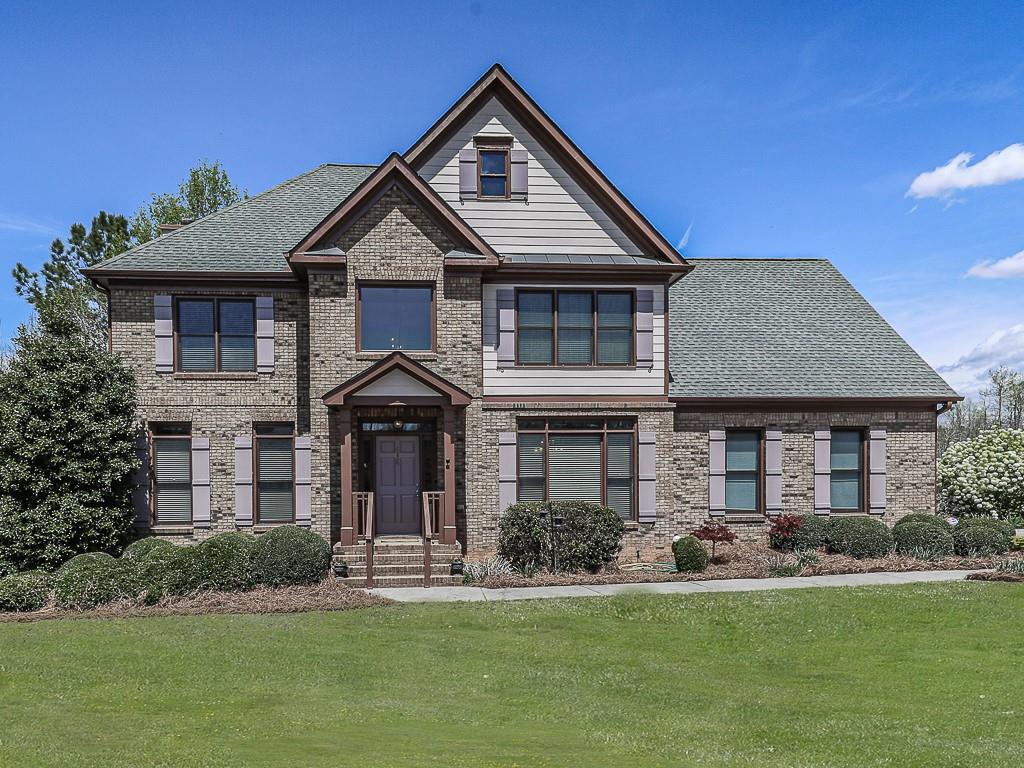 a front view of a house with a yard