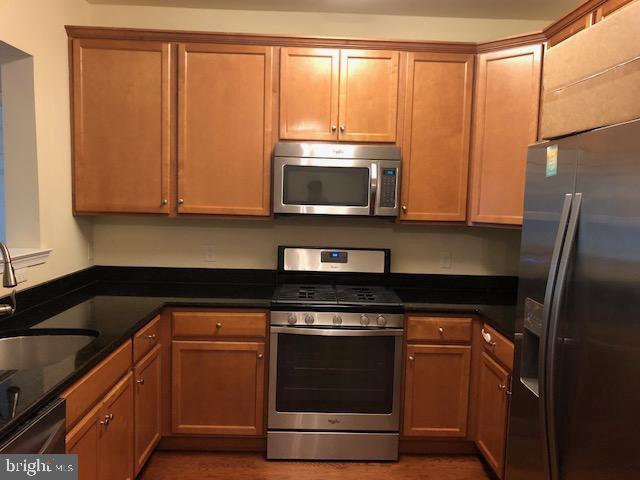 a kitchen with a stove microwave and sink