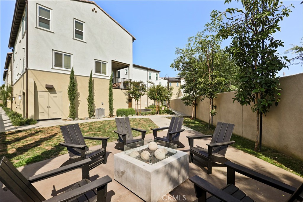 a view of a patio with couches table and chairs and potted plants