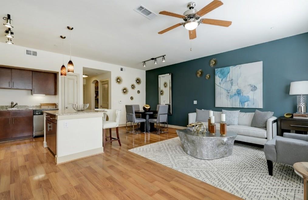 a living room with furniture and a wooden floor