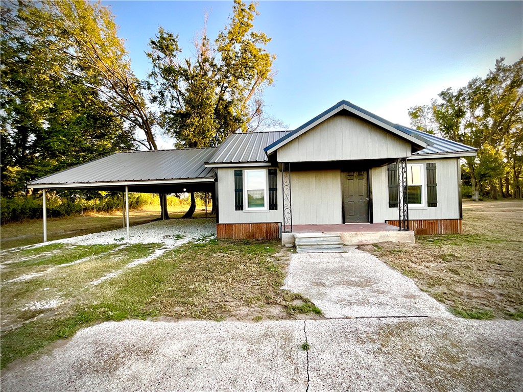 a front view of a house with a yard and porch