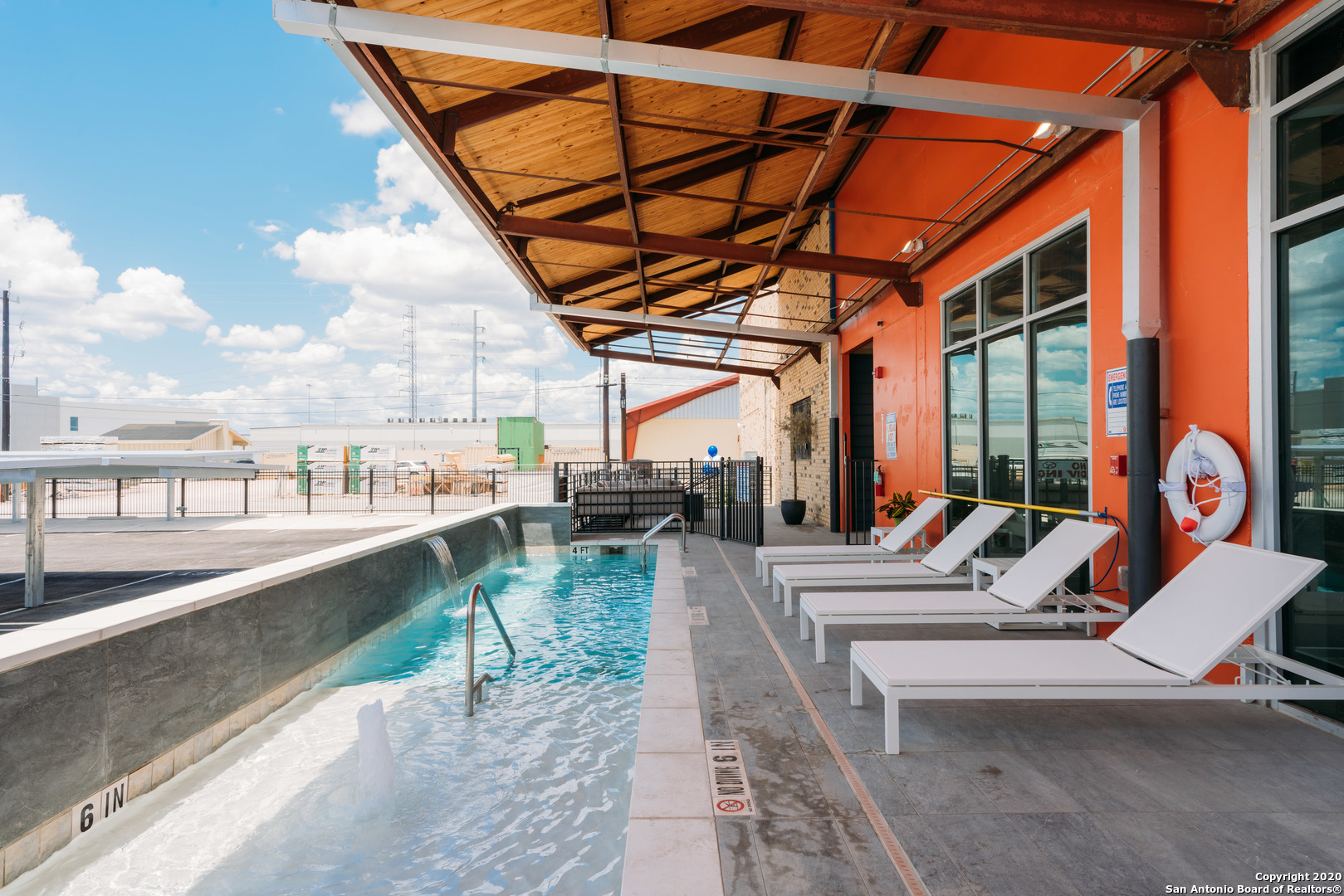 a view of a swimming pool with a lounge chair