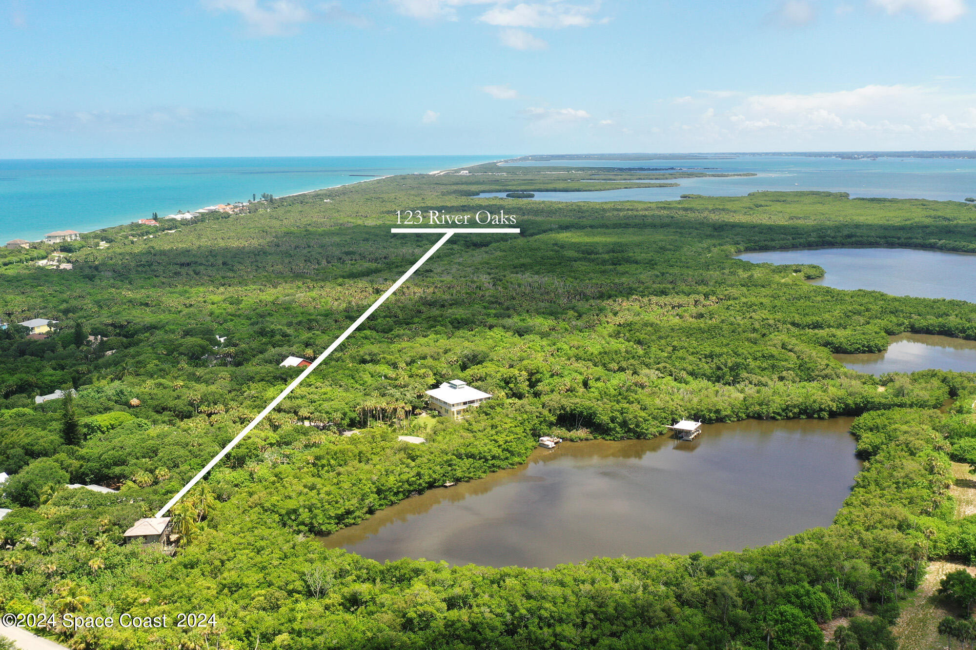 an aerial view of a houses with a yard