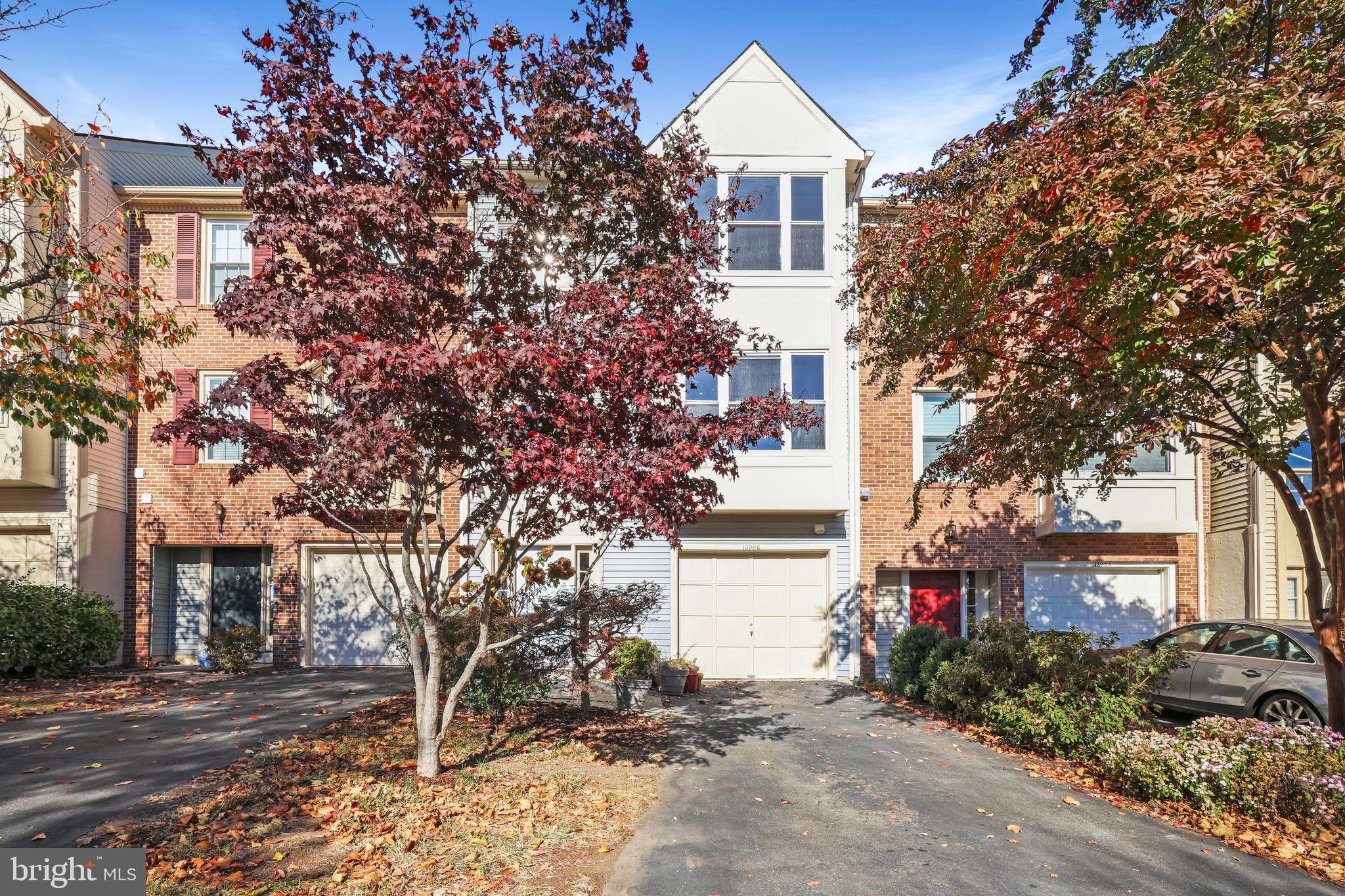 a view of a house with a tree and a yard