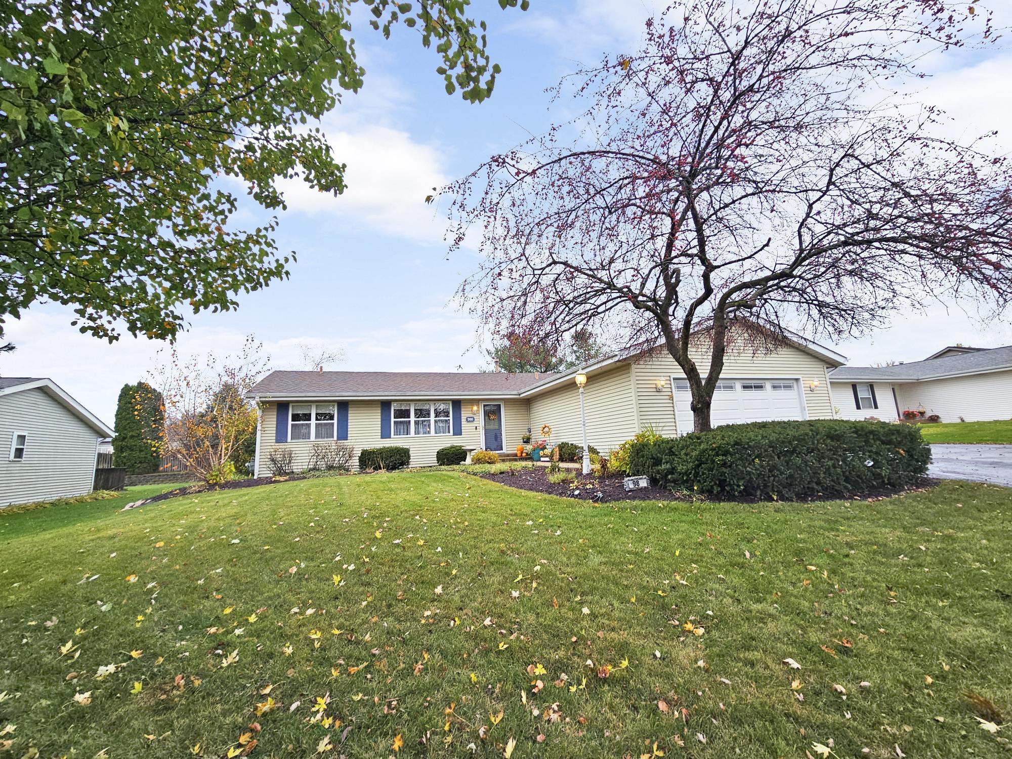 a view of a house with a big yard and large trees