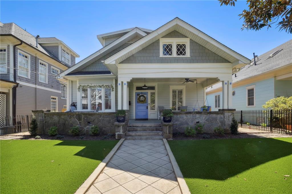 a front view of a house with a yard and outdoor seating