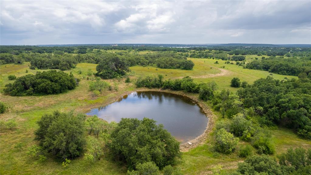 an aerial view of a houses with a lake view