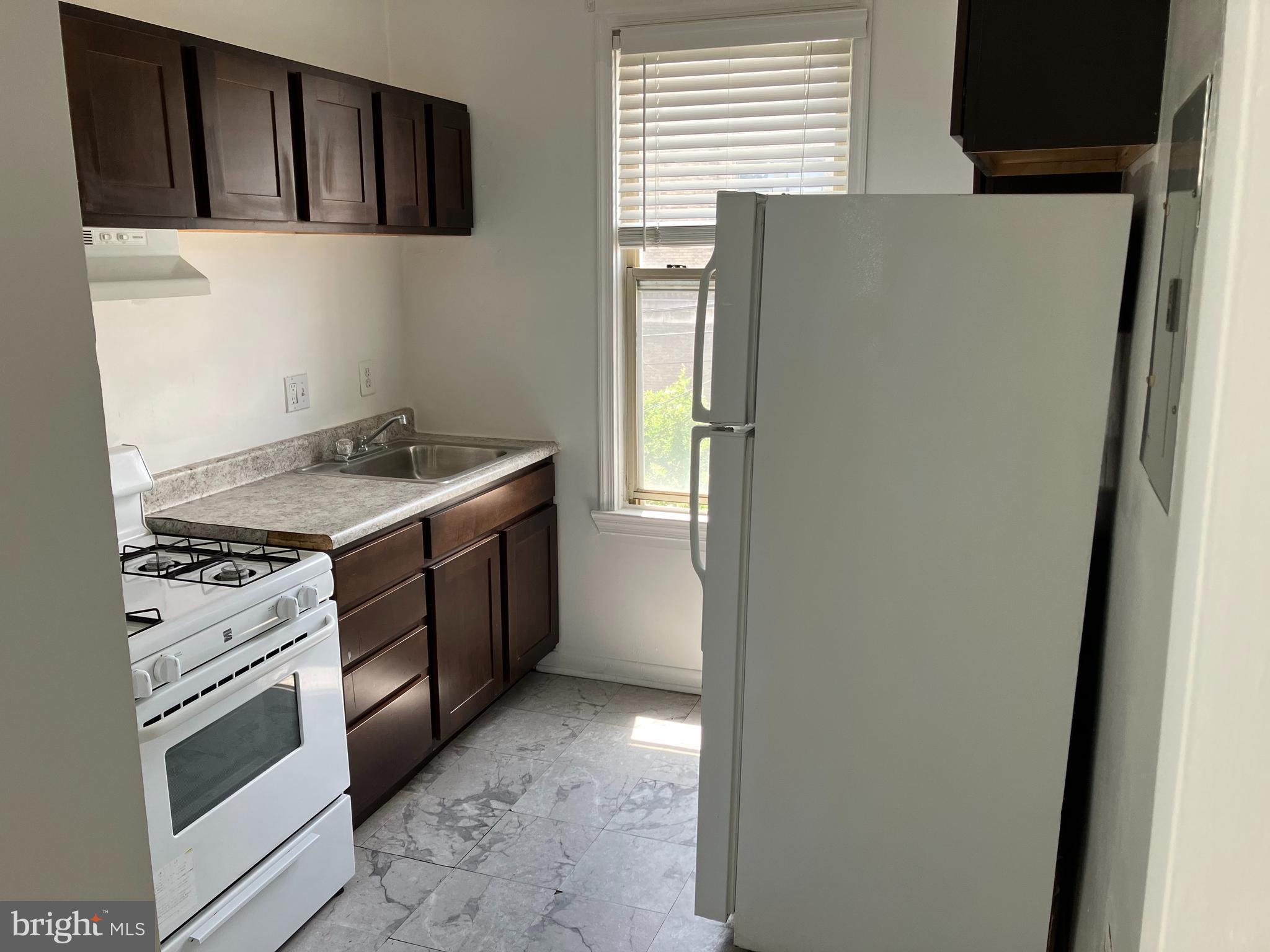 a kitchen with stainless steel appliances a stove and a refrigerator