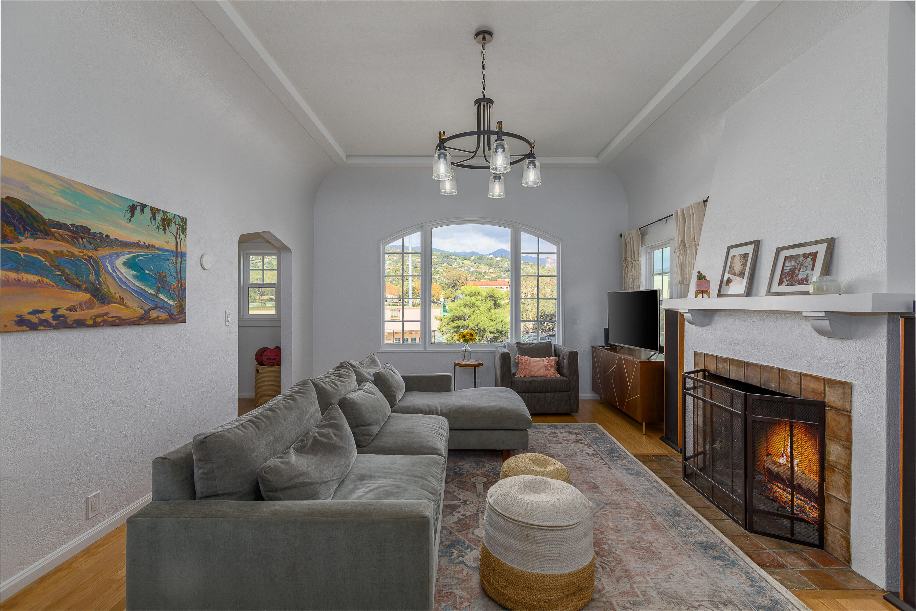 a living room with furniture a window and a fireplace