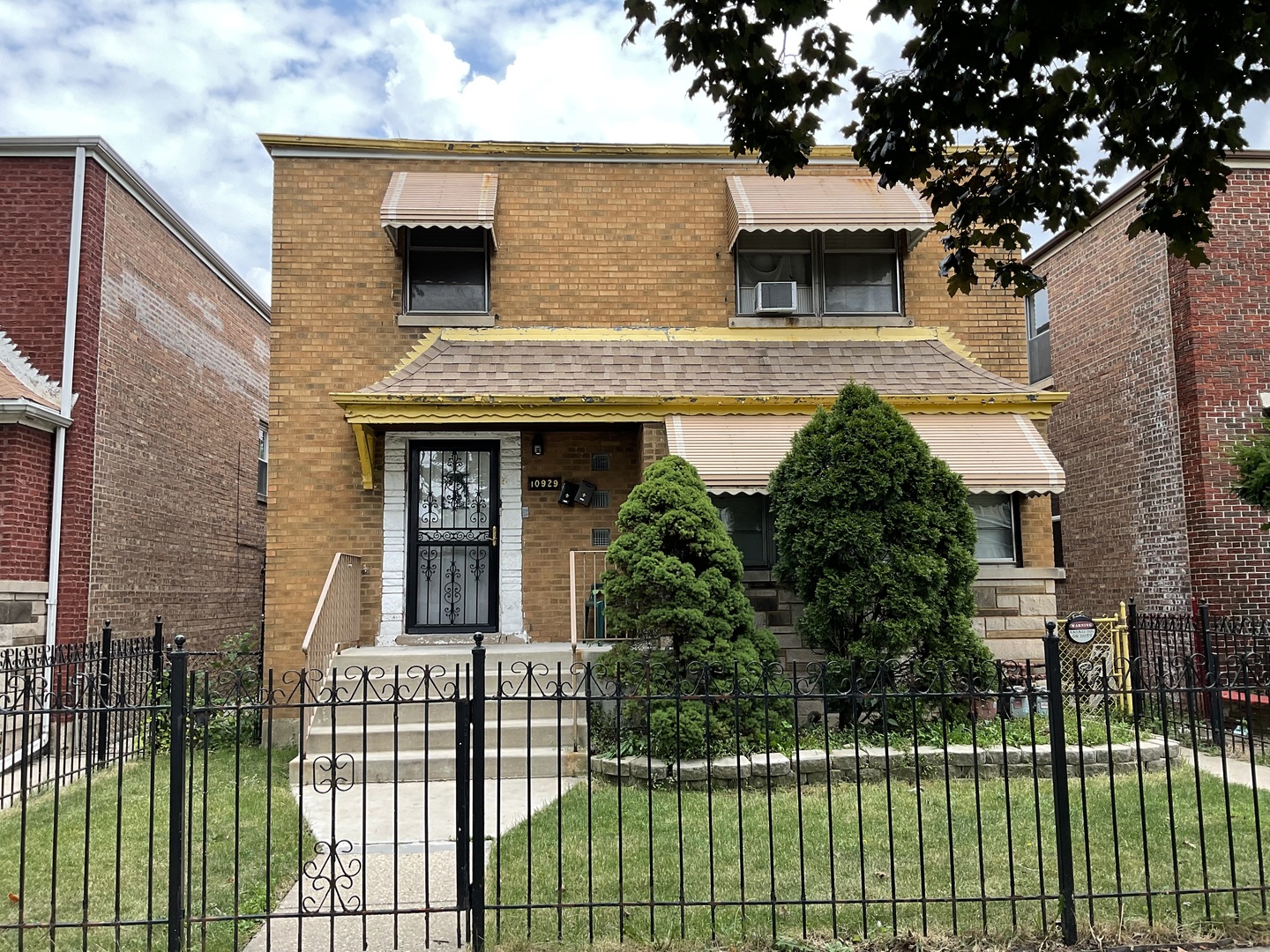 a front view of a house with a garden