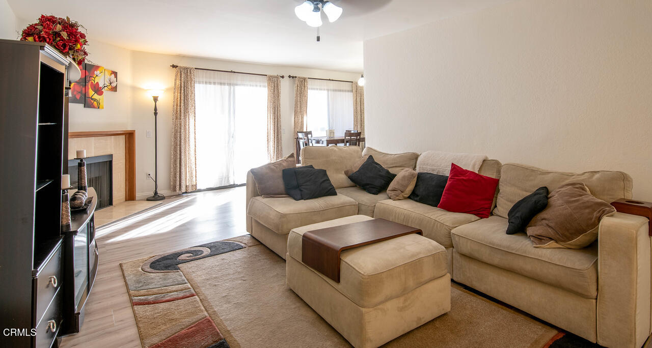 a living room with furniture and a fireplace