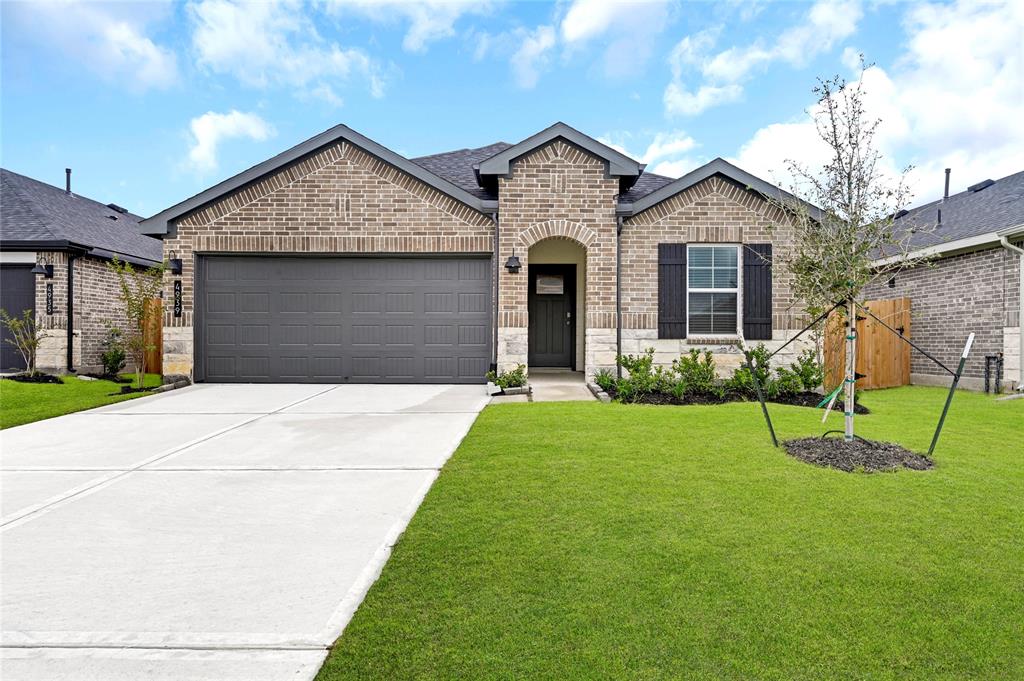 a front view of a house with a yard and garage