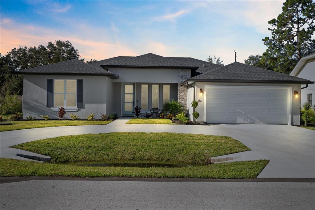 a view of a house with a yard and garage