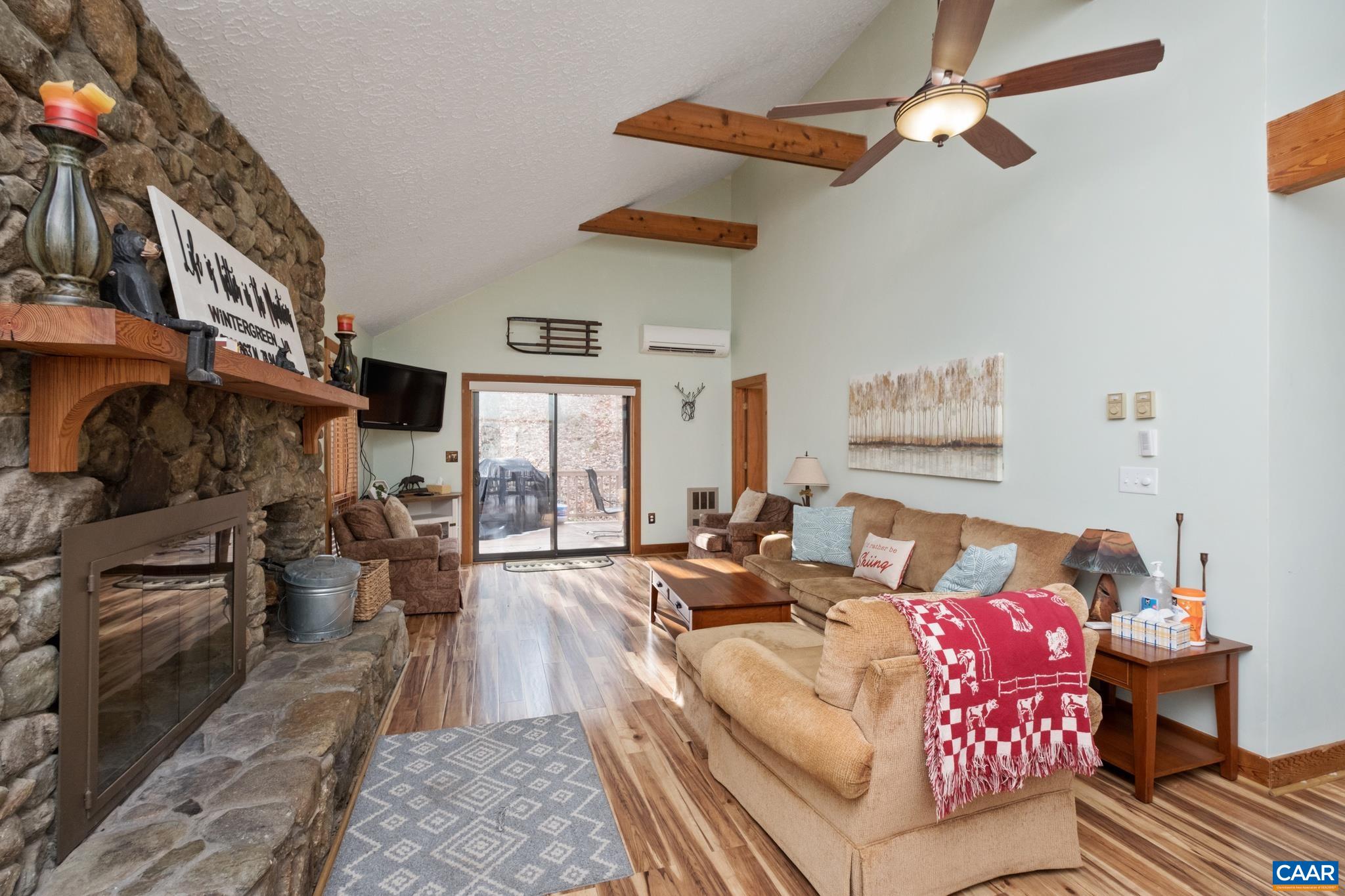 a living room with furniture fireplace and a flat screen tv