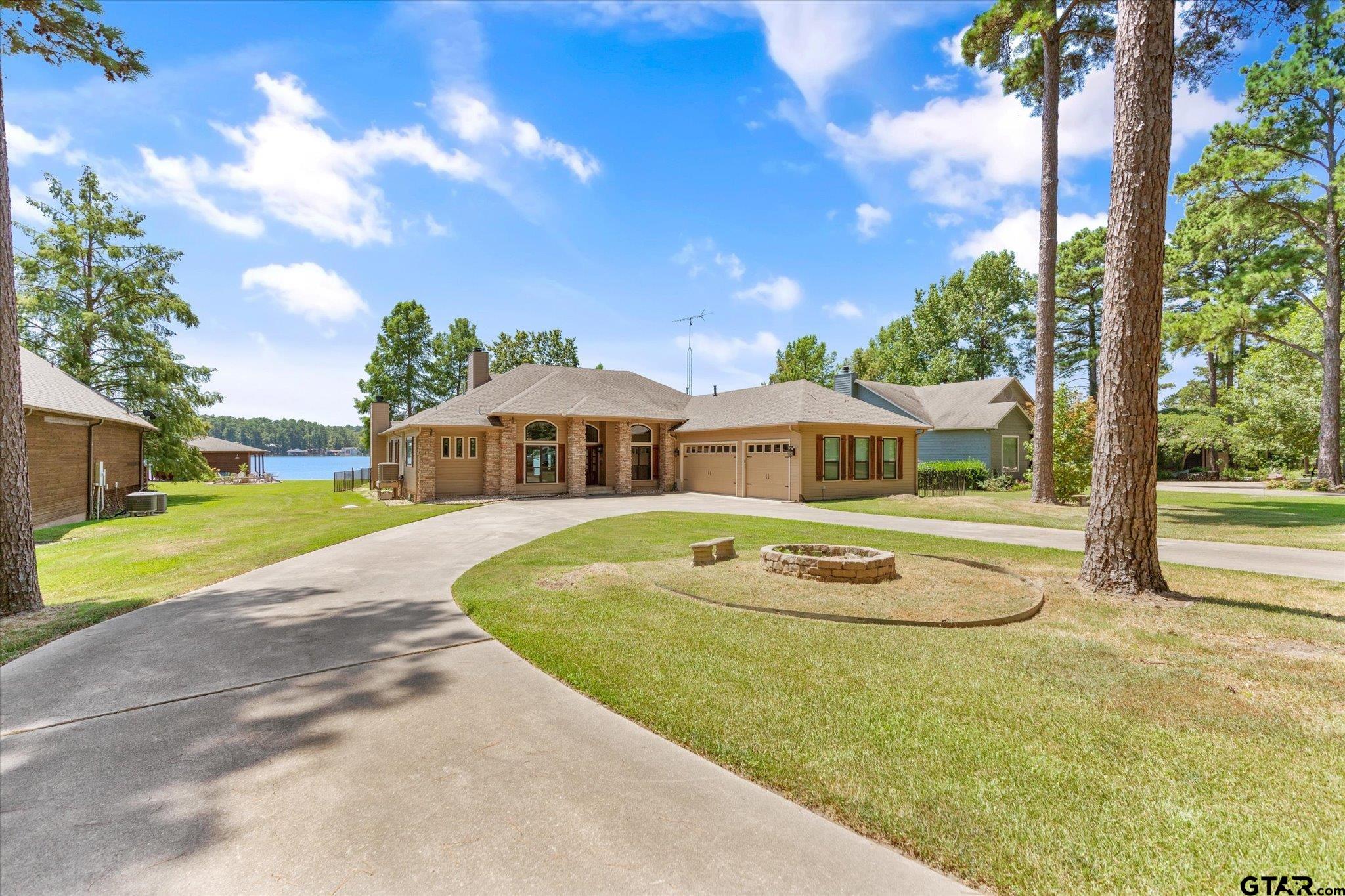 a front view of house with outdoor space and trees