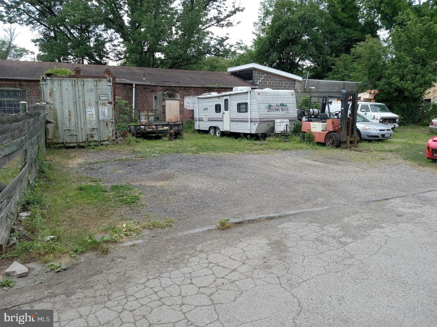 a front view of a house with a garden and parking space